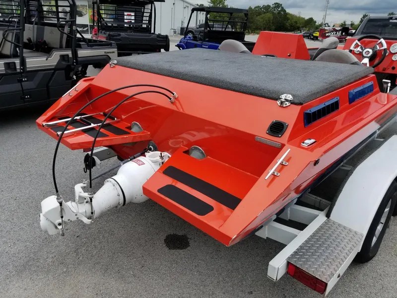 Slide: The Image of Orange 2012 custom welded boat on trailer, rear view with motor and seating. - 5