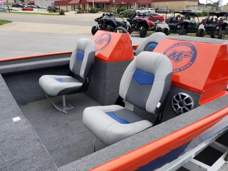 Slide: The Image of Custom welded boat interior with gray and blue seats, orange accents, and speaker system, 2012 model. - 8
