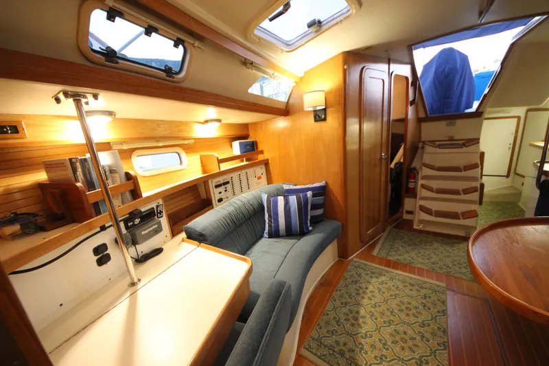 Slide: The Image of Interior of 1993 Catalina 42 MKI sailboat with cozy seating and wooden accents. - 11