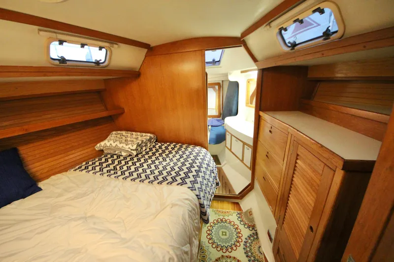 Slide: The Image of Cozy cabin interior of 1993 Catalina 42 MKI sailboat with wooden furnishings and bed. - 12