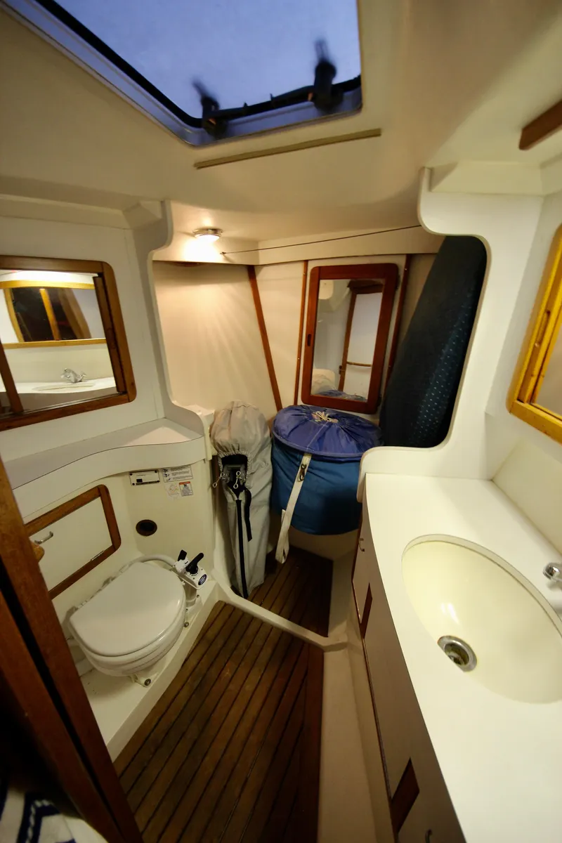Slide: The Image of 1993 Catalina 42 MKI yacht bathroom with wooden flooring and compact design. - 16