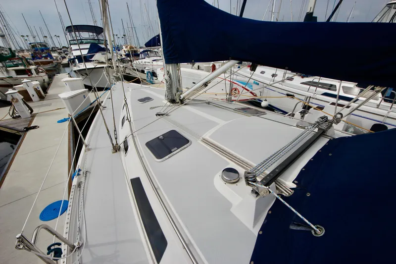 Slide: The Image of Sailboat Catalina 42 MKI 1993 docked at marina, showcasing deck and rigging. - 23