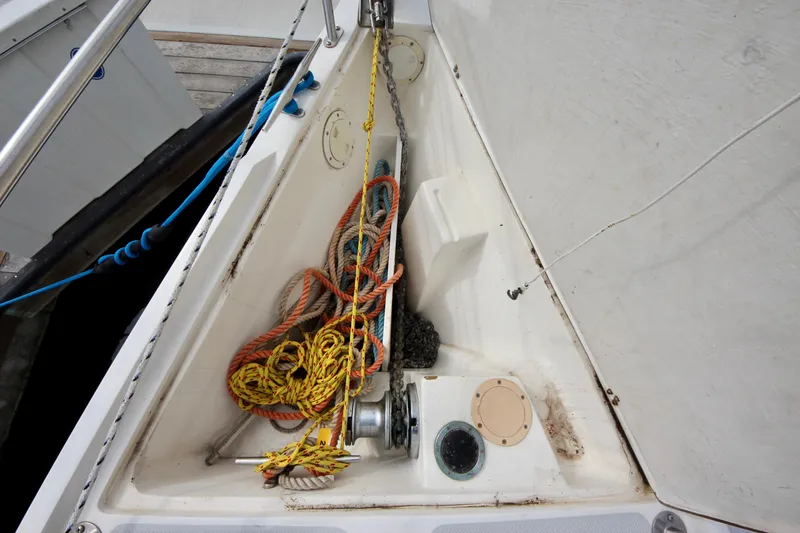 Slide: The Image of Anchor locker of a 1993 Catalina 42 MKI sailboat with ropes and chains. - 33