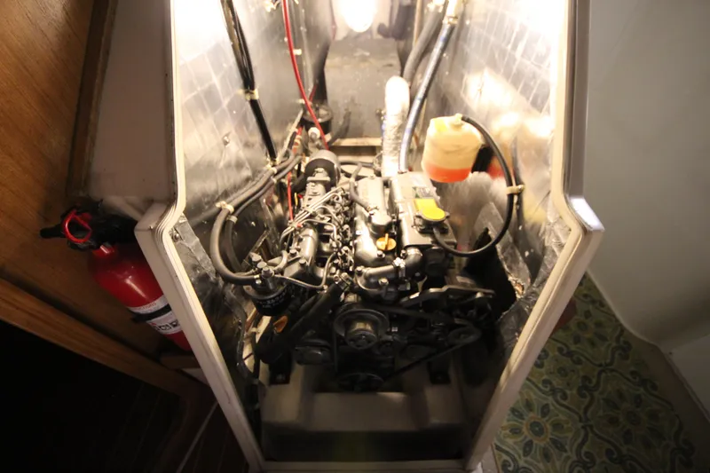 Slide: The Image of Engine compartment of a 1993 Catalina 42 MKI sailboat, featuring visible components and fire extinguisher. - 35