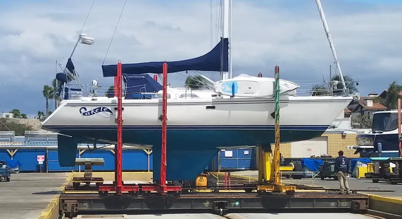 Slide: The Image of 1993 Catalina 42 MKI sailboat on a lift in a marina setting. - 36
