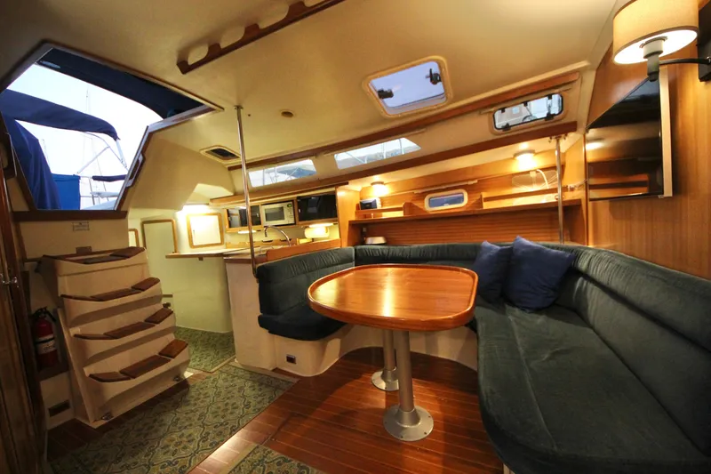 Slide: The Image of Interior of 1993 Catalina 42 MKI sailboat with cozy seating and wooden table. - 5