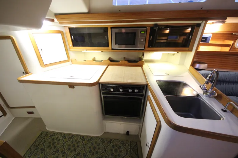 Slide: The Image of 1993 Catalina 42 MKI yacht kitchen with stove, microwave, and sink. - 7