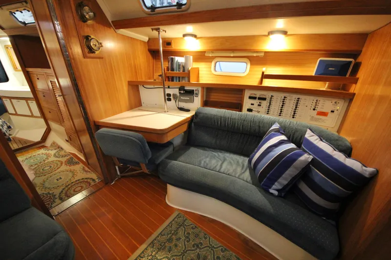Slide: The Image of Interior of 1993 Catalina 42 MKI sailboat with cozy seating and navigation station. - 9
