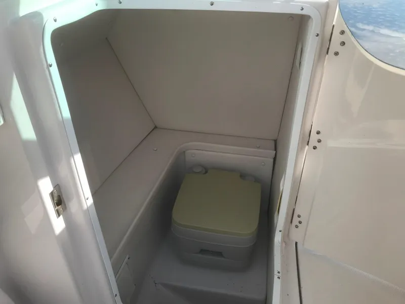 Slide: The Image of 2017 Four Winns HD220 OB boat interior with compact toilet compartment. - 11