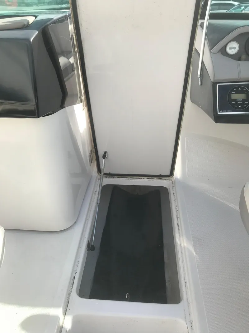 Slide: The Image of 2017 Four Winns HD220 OB boat interior with storage compartment. - 12