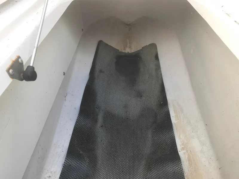 Slide: The Image of Interior view of 2017 Four Winns HD220 OB boat, showing textured flooring. - 13