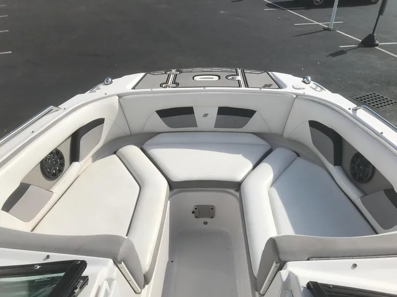 Slide: The Image of 2017 Four Winns HD220 OB boat interior with white seating and storage compartments. - 14