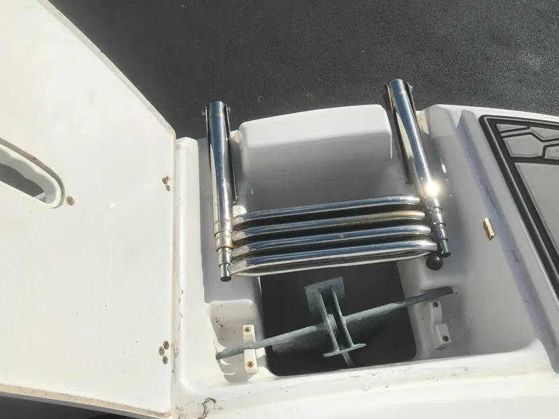 Slide: The Image of 2017 Four Winns HD220 OB boat ladder compartment with stainless steel ladder. - 15