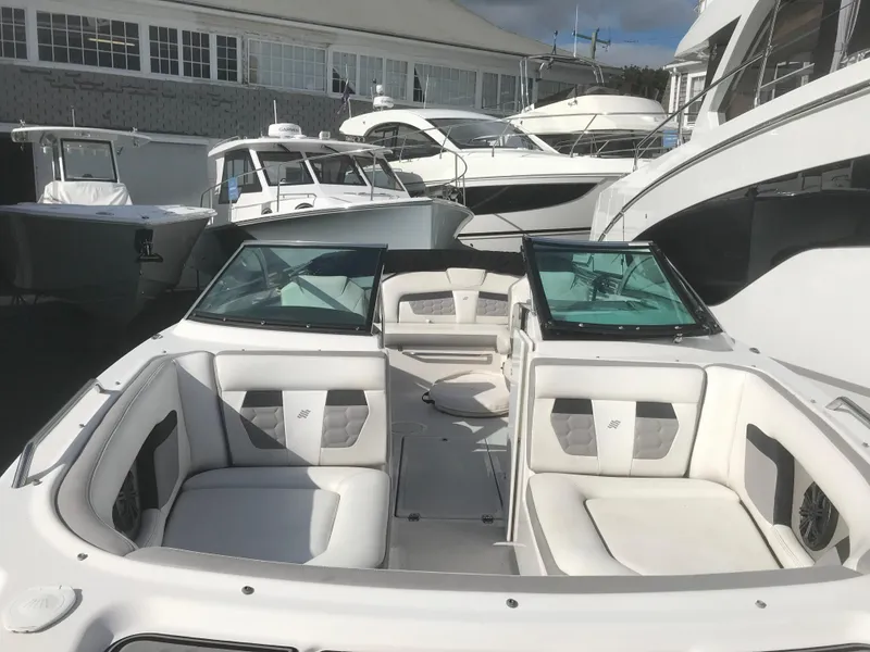 Slide: The Image of 2017 Four Winns HD220 OB boat with spacious seating, docked among other boats. - 16