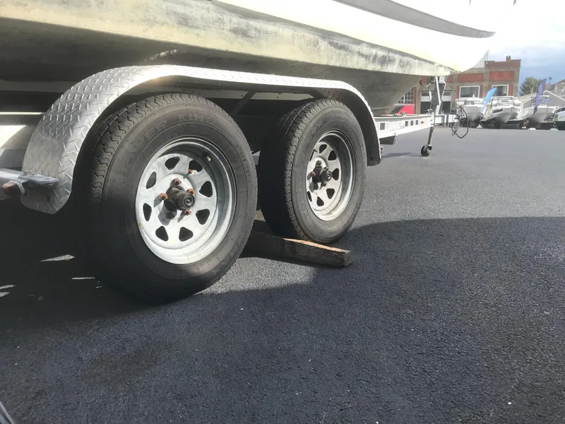 Slide: The Image of Trailer wheels of 2017 Four Winns HD220 OB boat on asphalt. - 20