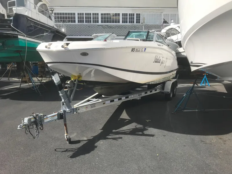 Slide: The Image of 2017 Four Winns HD220 OB boat on trailer in marina. - 21