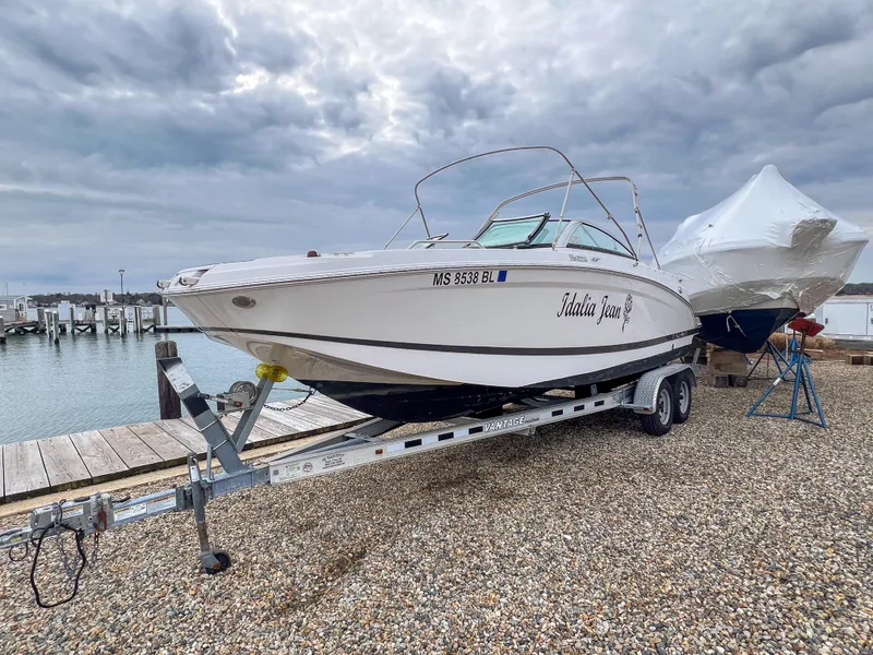 Slide: The Image of 2017 Four Winns HD220 OB boat on trailer by the dock, cloudy sky. - 23