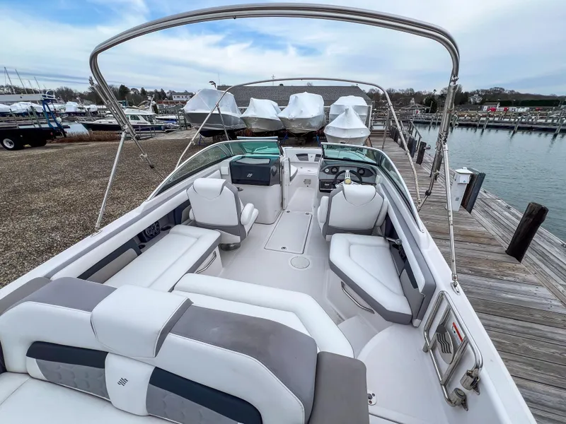 Slide: The Image of 2017 Four Winns HD220 OB boat with spacious seating at a dock. - 4