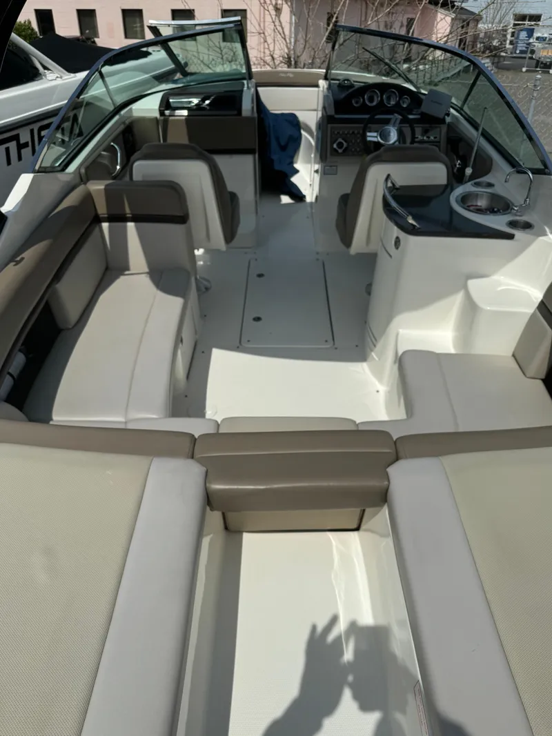 Slide: The Image of 2013 Sea Ray 270 SLX boat interior with beige seating and modern dashboard. - 11
