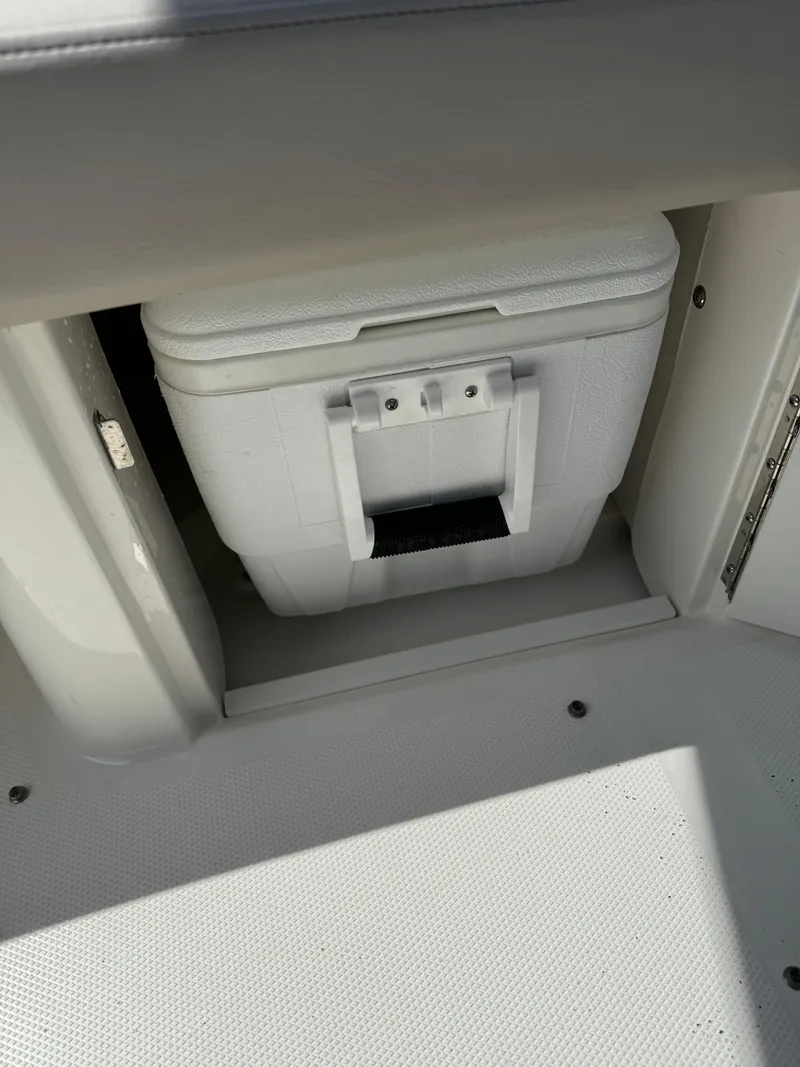 Slide: The Image of White cooler stored in a compartment on a 2013 Sea Ray 270 SLX boat. - 12