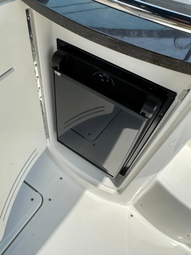 Slide: The Image of 2013 Sea Ray 270 SLX boat interior with built-in storage compartment. - 14