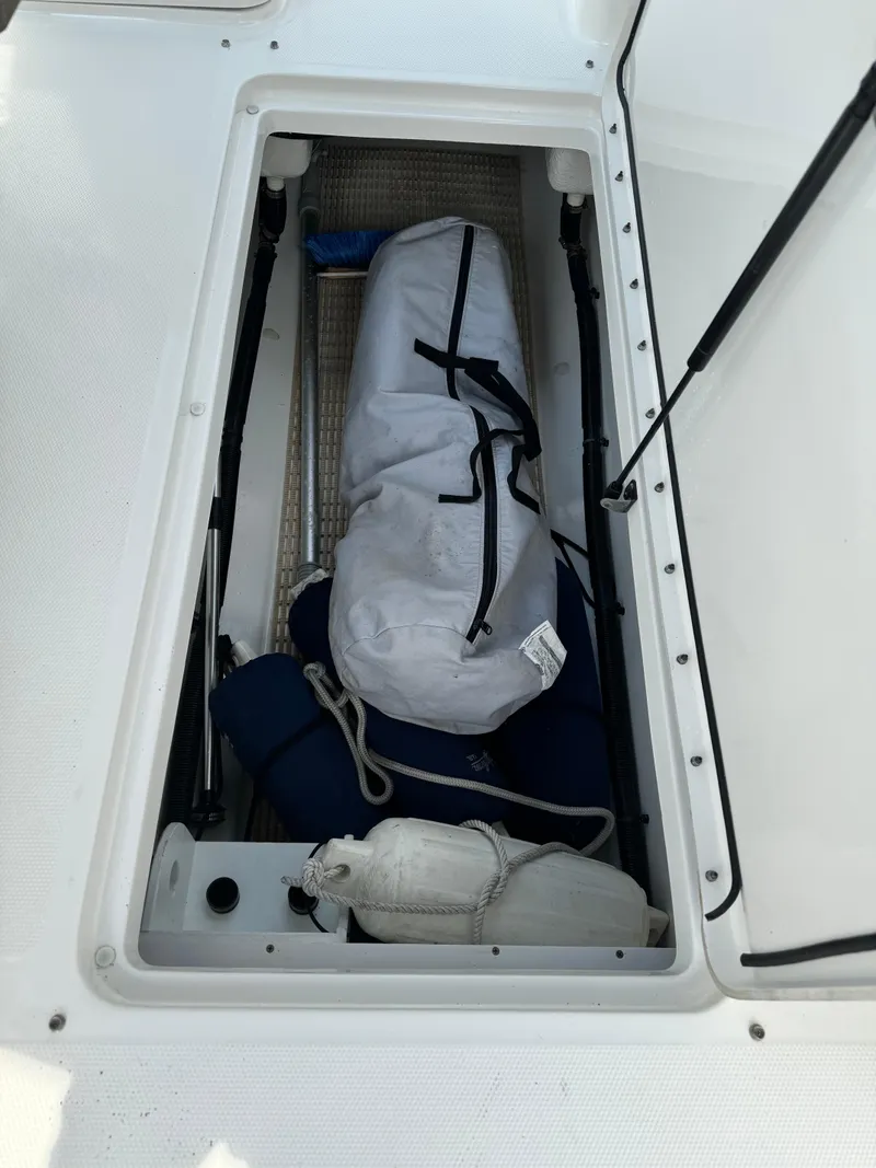 Slide: The Image of Storage compartment of 2013 Sea Ray 270 SLX boat with gear and equipment. - 16