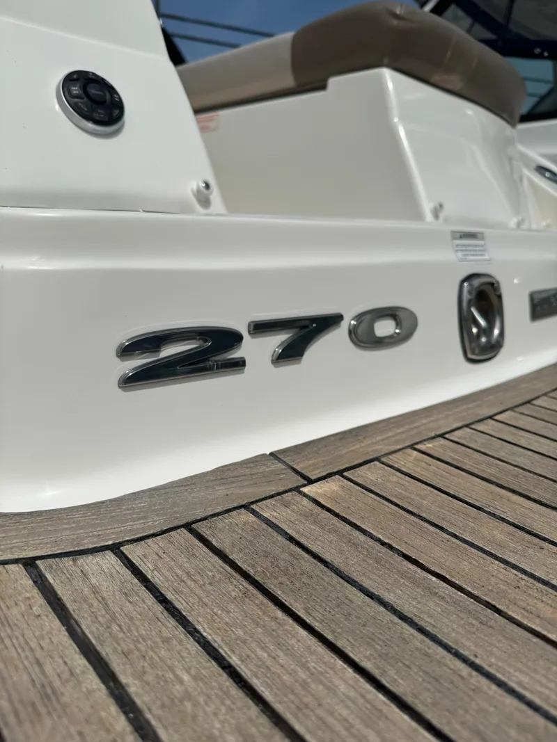 Slide: The Image of 2013 Sea Ray 270 SLX boat, close-up of model emblem on deck. - 20