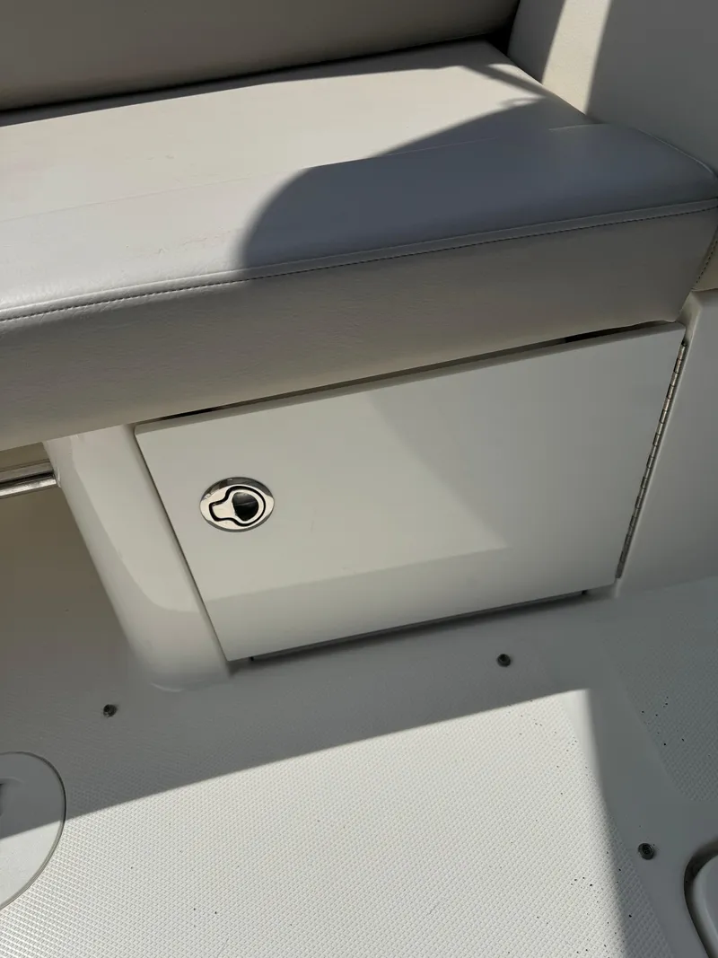 Slide: The Image of 2013 Sea Ray 270 SLX boat storage compartment with cushioned seating. - 23