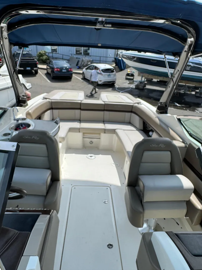 Slide: The Image of 2013 Sea Ray 270 SLX boat interior with spacious seating and canopy. - 26