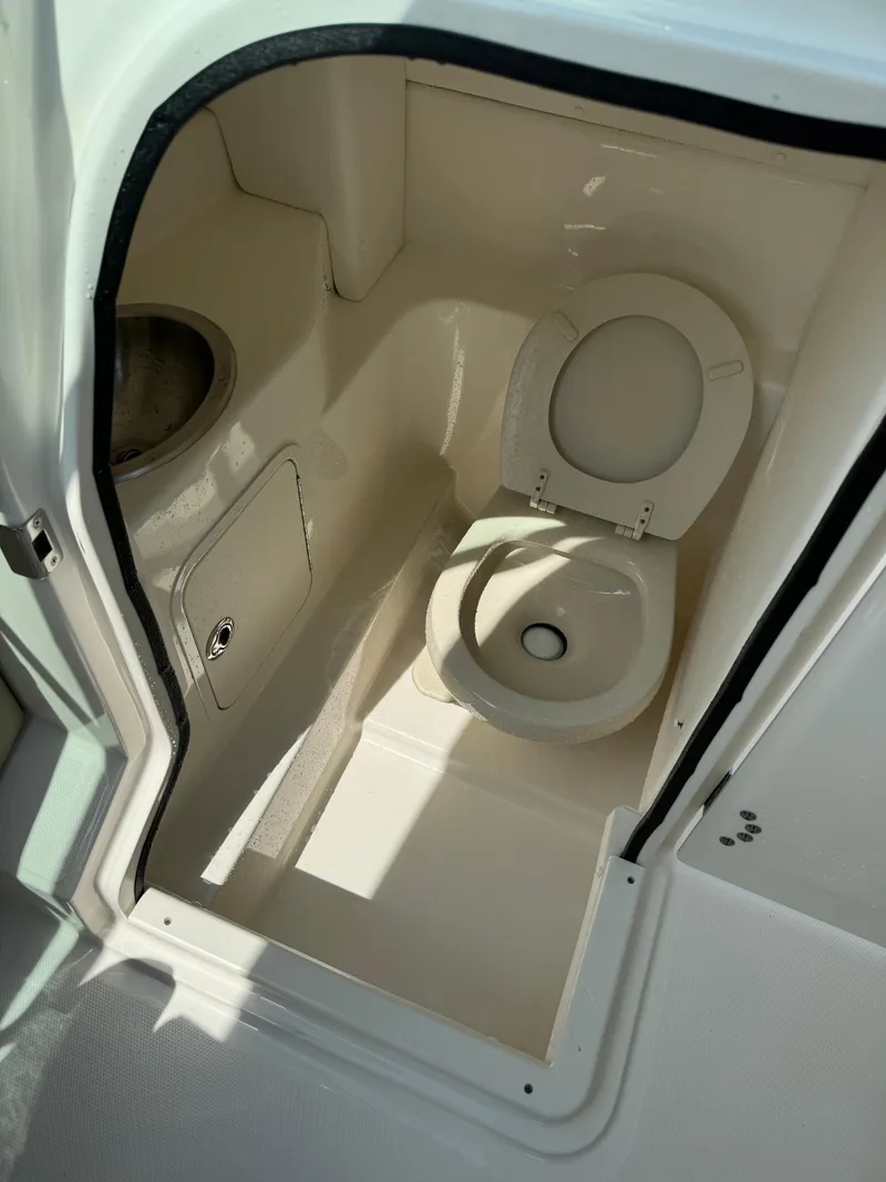 Slide: The Image of 2013 Sea Ray 270 SLX boat bathroom interior with toilet and sink. - 30