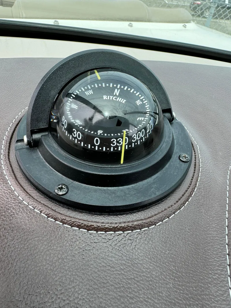 Slide: The Image of Compass on 2013 Sea Ray 270 SLX boat dashboard, featuring Ritchie navigation. - 32