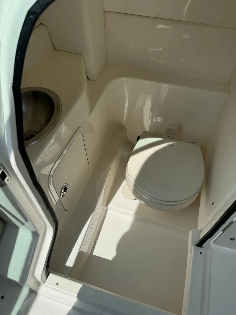 Slide: The Image of 2013 Sea Ray 270 SLX boat bathroom interior with toilet and sink. - 36