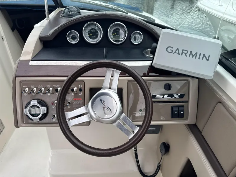 Slide: The Image of 2013 Sea Ray 270 SLX boat dashboard with Garmin navigation system. - 37