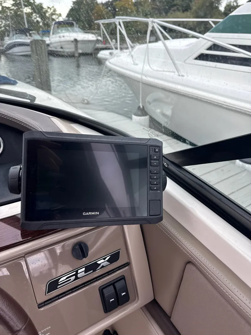 Slide: The Image of 2013 Sea Ray 270 SLX boat dashboard with Garmin GPS, docked in marina. - 39