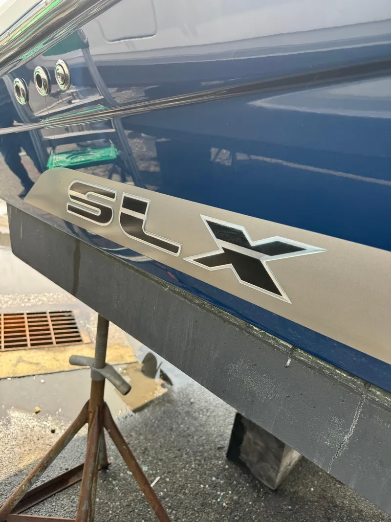 Slide: The Image of 2013 Sea Ray 270 SLX boat exterior with SLX logo. - 6