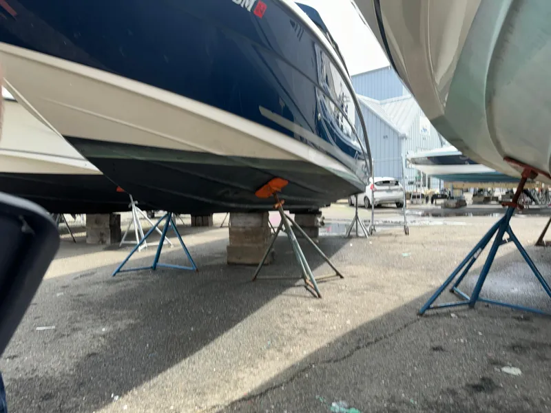 Slide: The Image of 2013 Sea Ray 270 SLX boat on stands in a marina. - 7