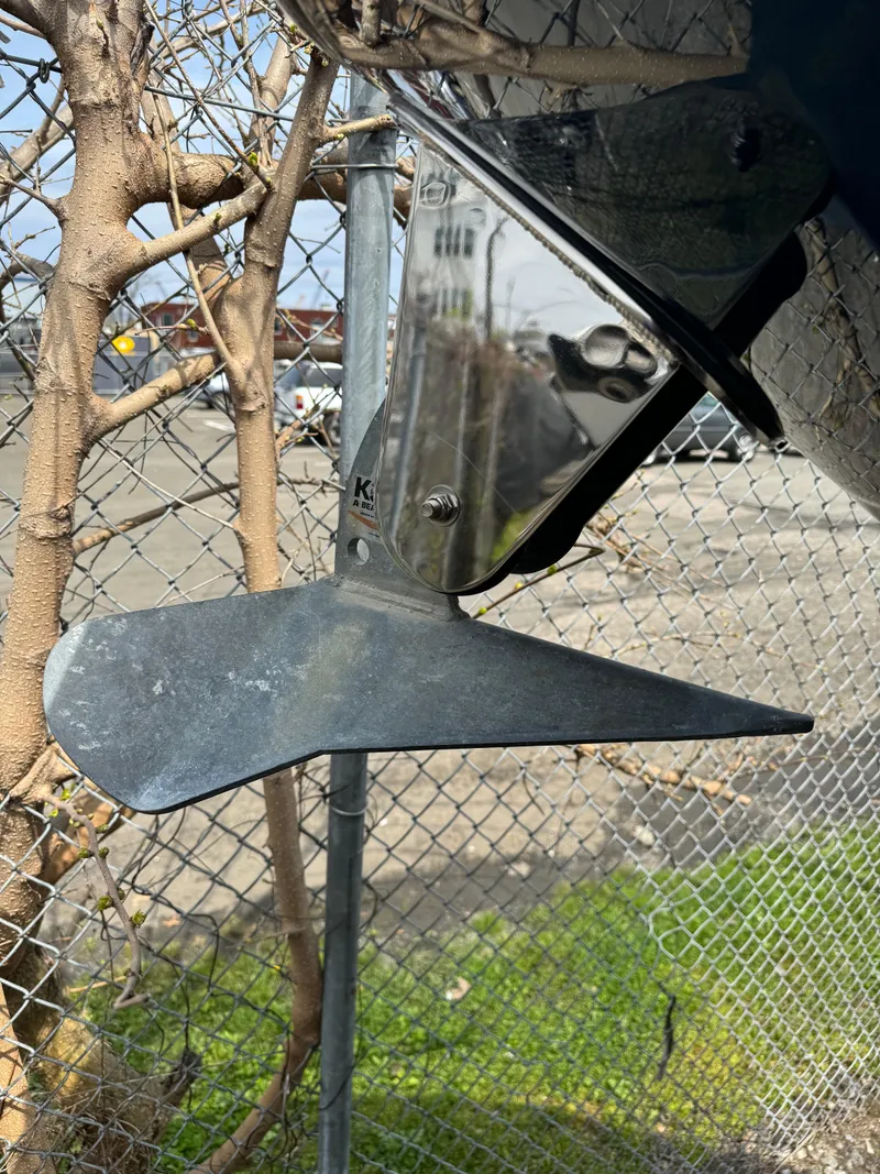 Slide: The Image of 2013 Sea Ray 270 SLX boat propeller near chain-link fence. - 9