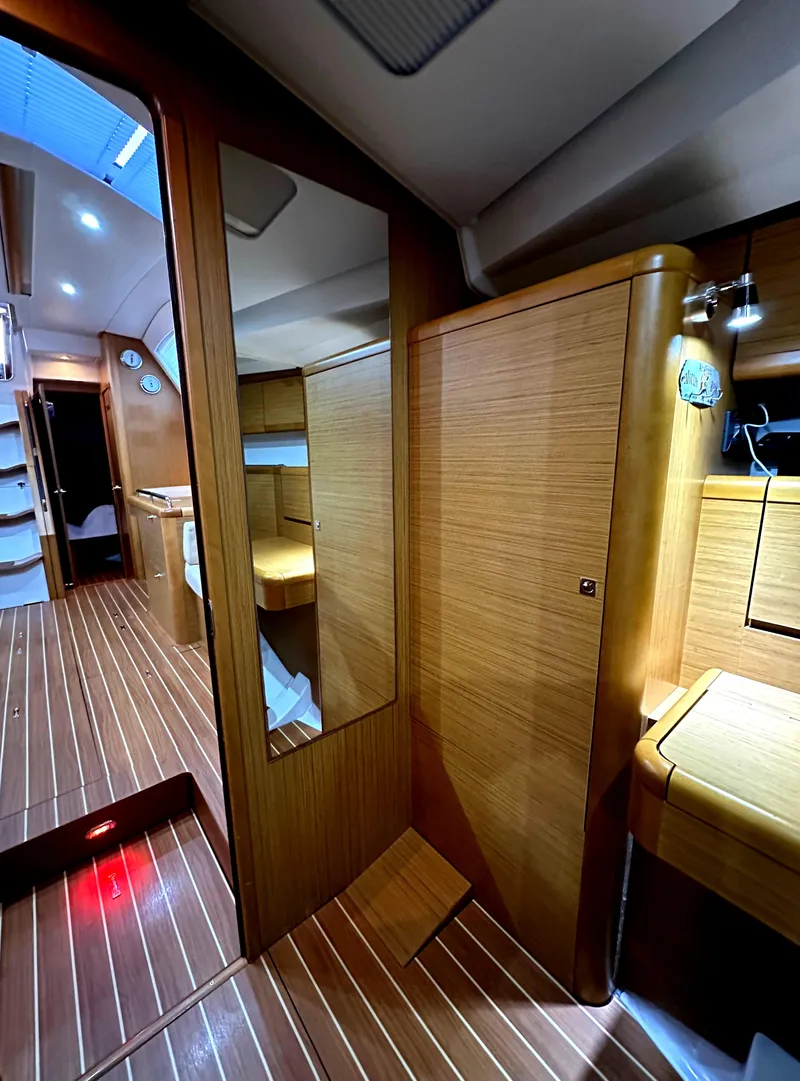 Slide: The Image of Interior of 2010 Jeanneau Sun Odyssey 50 DS, featuring sleek wood paneling and modern design. - 20