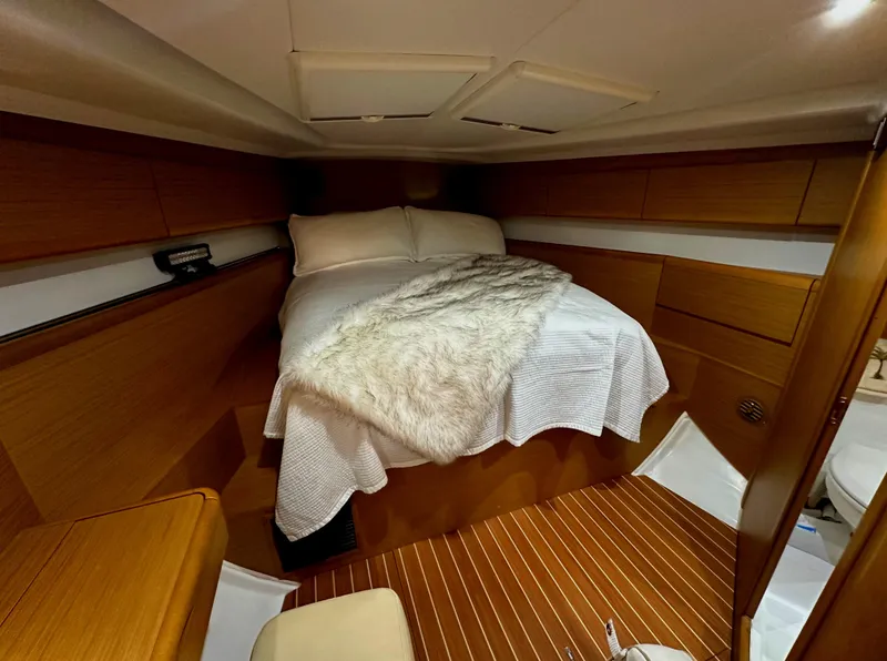 Slide: The Image of Cozy cabin interior of 2010 Jeanneau Sun Odyssey 50 DS with wooden finish and comfortable bedding. - 22