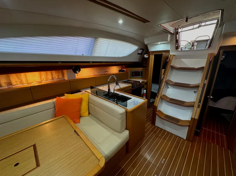 Slide: The Image of Luxurious interior of 2010 Jeanneau Sun Odyssey 50 DS yacht with modern kitchen and seating area. - 23