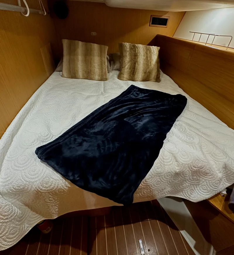 Slide: The Image of Cozy cabin interior of 2010 Jeanneau Sun Odyssey 50 DS with bed and pillows. - 26