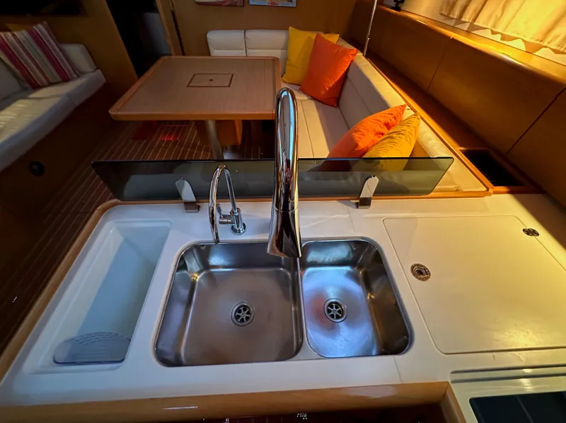 Slide: The Image of Modern kitchen area in 2010 Jeanneau Sun Odyssey 50 DS yacht with sink and seating. - 34