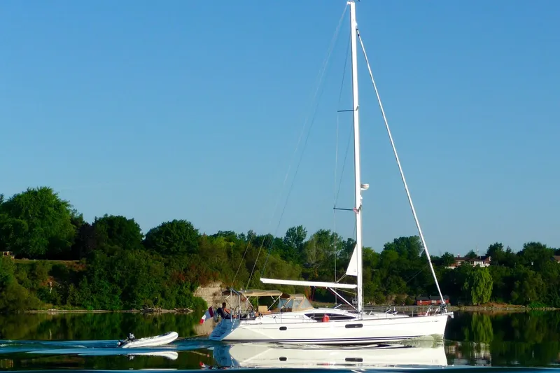 Slide: The Image of 2010 Jeanneau Sun Odyssey 50 DS sailing on calm water with lush green background. - 35