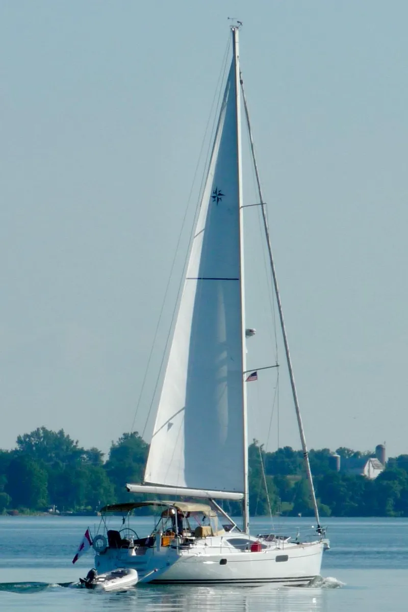 Slide: The Image of 2010 Jeanneau Sun Odyssey 50 DS sailing on calm waters with trees in the background. - 36