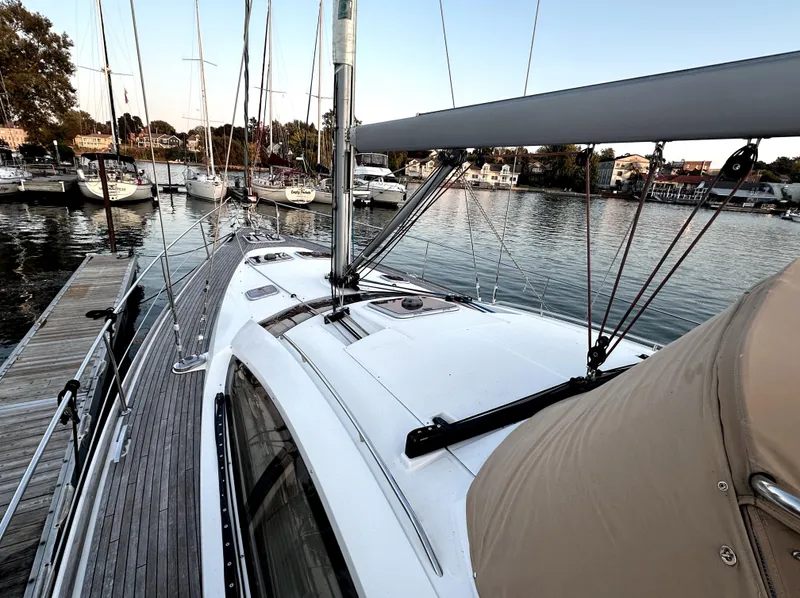 Slide: The Image of Jeanneau Sun Odyssey 50 DS sailboat docked, showcasing sleek deck design, 2010 model. - 5