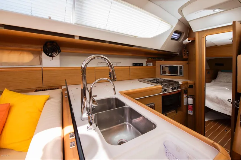 Slide: The Image of Interior of 2010 Jeanneau Sun Odyssey 50 DS yacht, featuring modern kitchen and cozy cabin. - 53