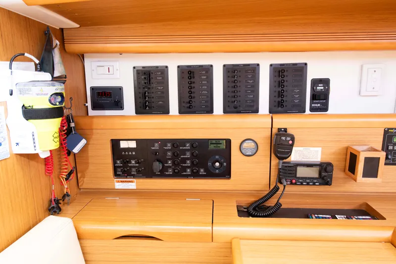 Slide: The Image of Control panel of a 2010 Jeanneau Sun Odyssey 50 DS sailboat, featuring navigation and communication equipment. - 56