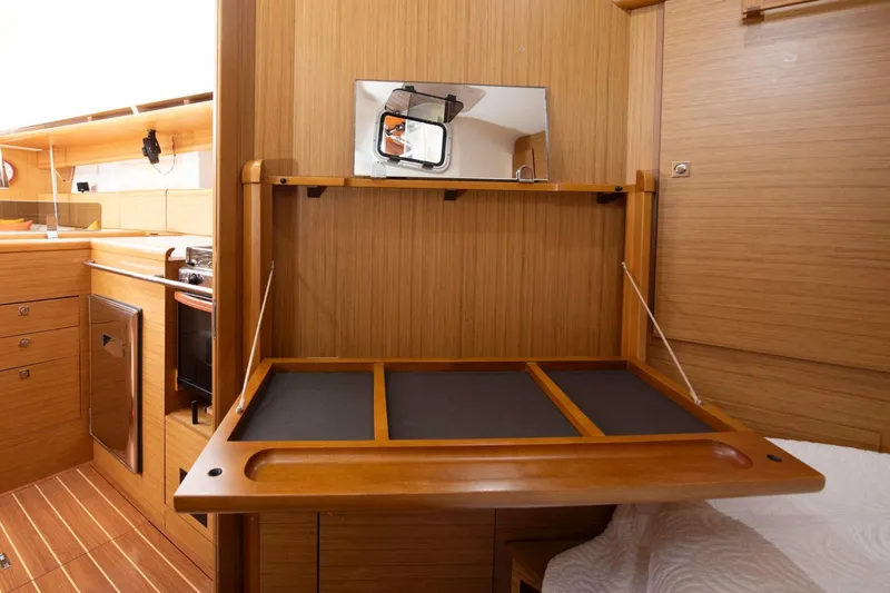 Slide: The Image of Interior of 2010 Jeanneau Sun Odyssey 50 DS yacht with wooden cabinetry and foldable desk. - 59