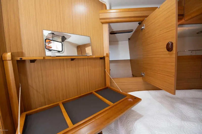 Slide: The Image of Interior of 2010 Jeanneau Sun Odyssey 50 DS yacht with wooden cabinetry and mirror. - 60