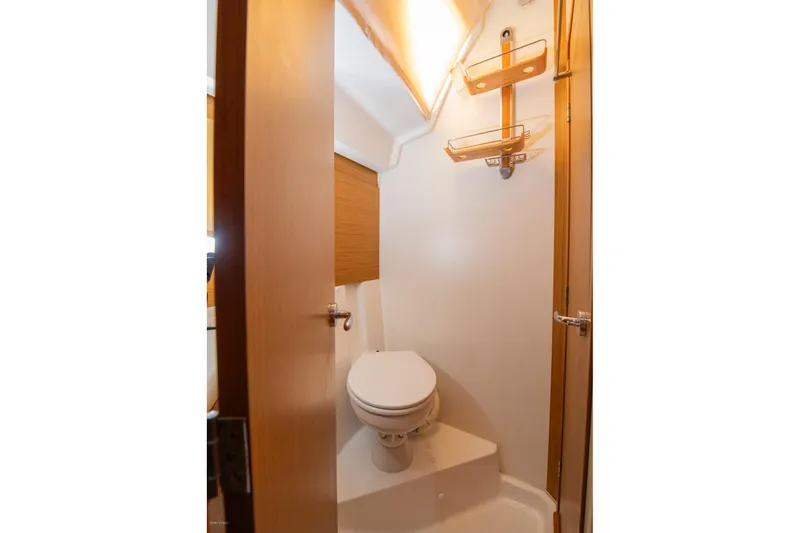 Slide: The Image of Compact bathroom in 2010 Jeanneau Sun Odyssey 50 DS yacht, featuring a toilet and wooden accents. - 62